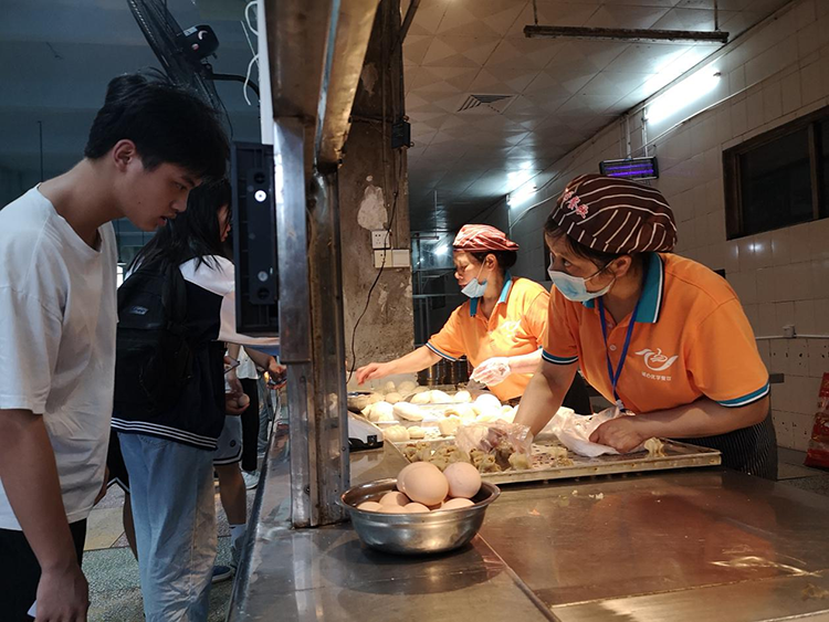 食堂打饭的阿姨们耐心地等待着考生挑选自己爱吃的食物，为近两千名师生们服务，她们乐在其中。