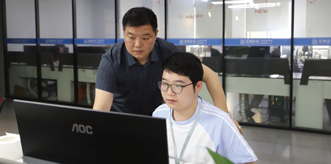 苏勇（左）指导员工修改标书.png