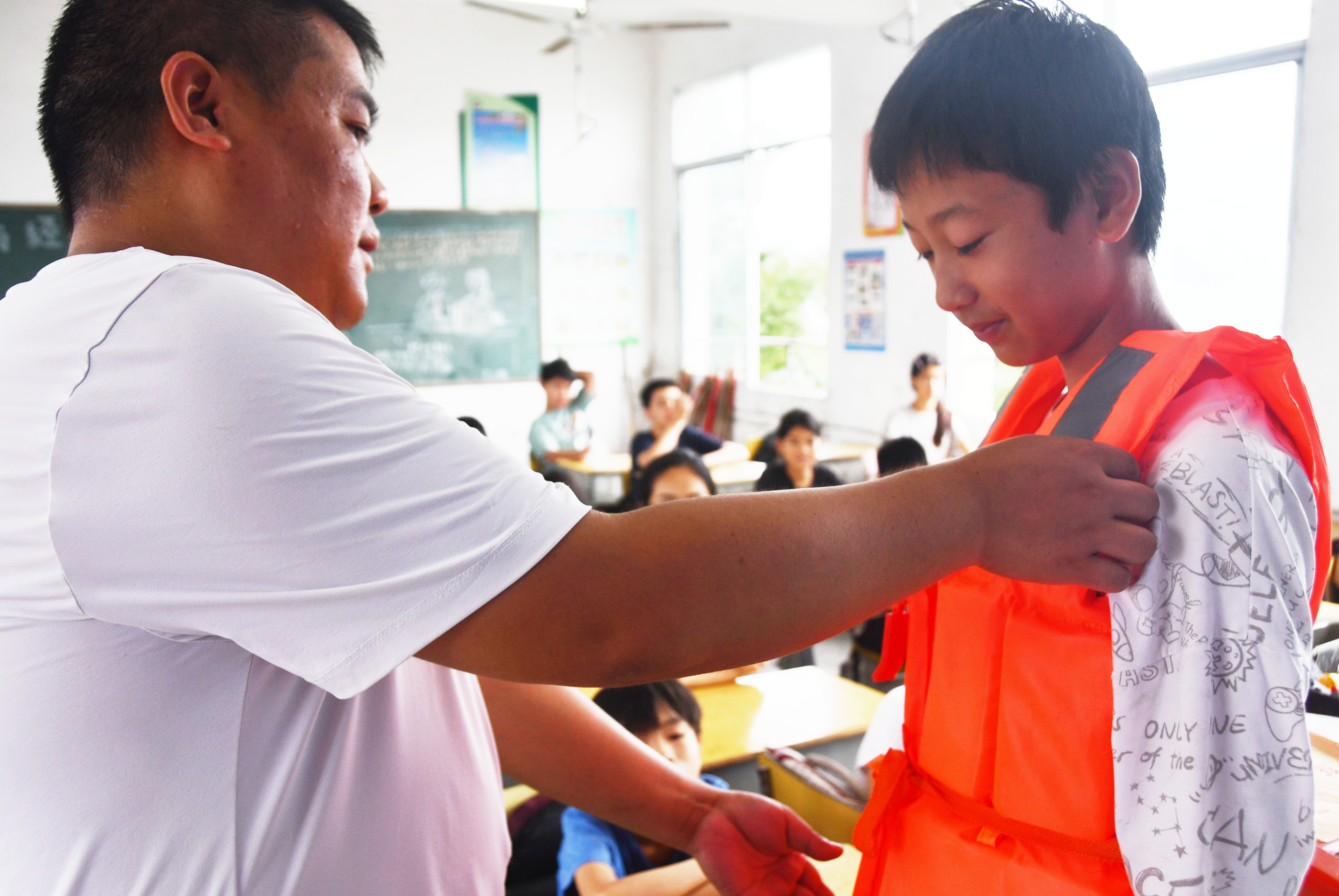 在湖南省永州市江永县潇浦镇允山中心小学，老师给学生讲解救生圈救生衣使用方法。田如瑞摄 (2).JPG