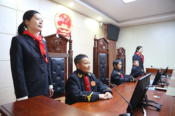 图为学生们在法官的带领下沉侵式体验模拟法庭.JPG