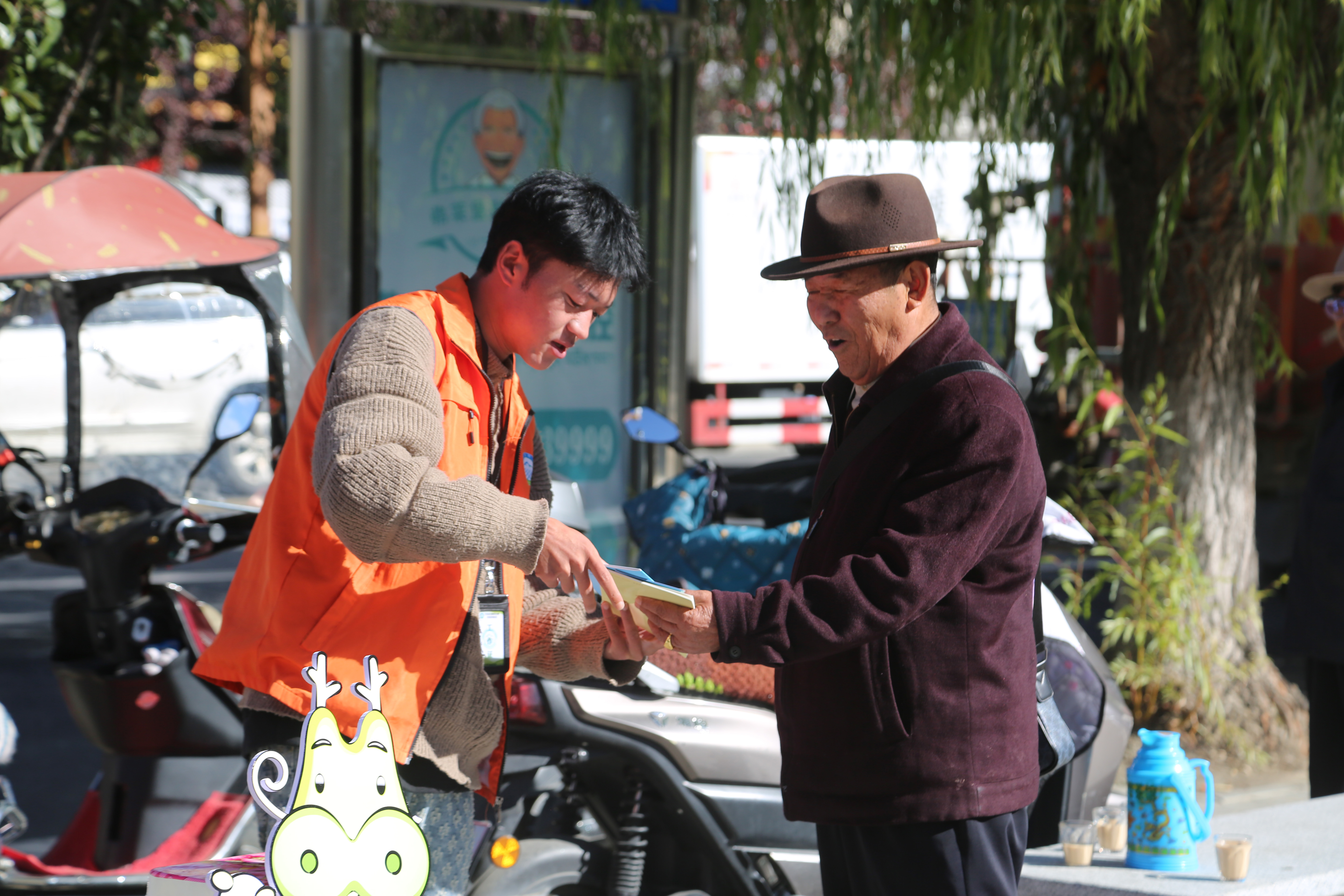 图为工作人员发放宣传手册.jpg