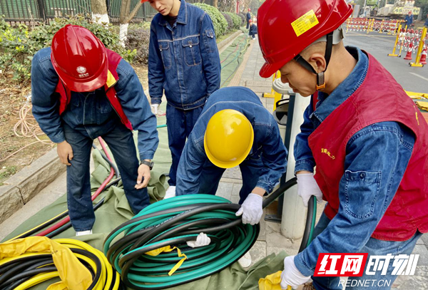 12月9日，大型综合电缆不停电作业现场，带电作业人员正在清理电缆。