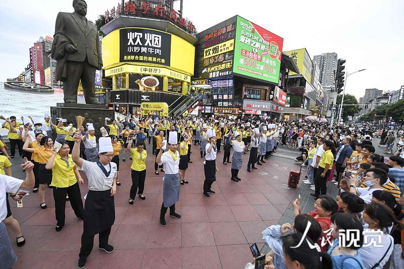 2020年8月5日，当日，湖南长沙黄兴路步行街的百余位厨师、服务员等餐饮从业者，手举锅铲、勺子、菜单等道具跳起《无价之姐》的舞蹈，用快闪方式庆祝长沙餐饮业复工。 杨华峰(湖南分社)/中新社