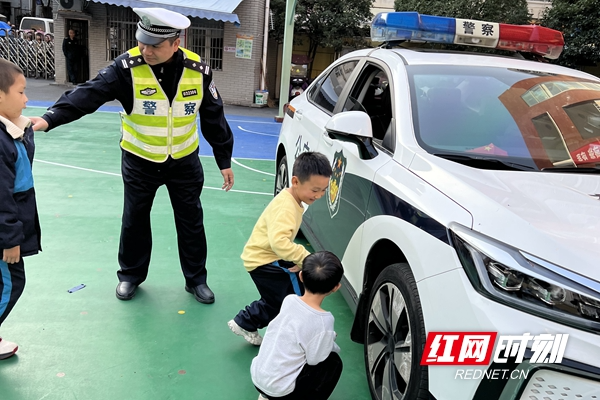 汽车“驶”进校园 交警带领学生和家长零距离体验汽车盲区