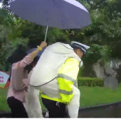 江永:大雨挡不住温情 交警背送受伤考生暖心护航高考
