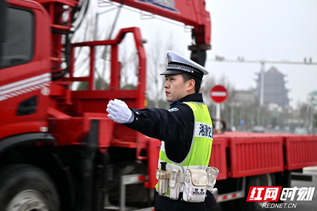 今年3月，交管支队民警在雨湖区沿江路开展专项交通疏导，护航涉企工程车辆通行。.jpg