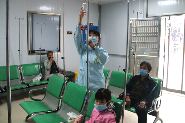5月8日，新田县中医医院门诊部护士雷静在为患者更换输液瓶。 郑有为摄.JPG