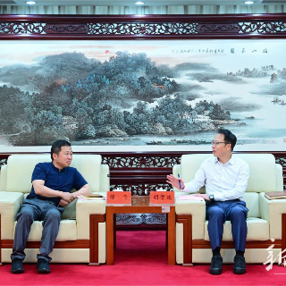 胡贺波会见新华社上海证券报社谭飞一行