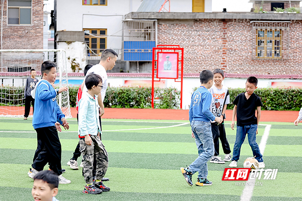 平安人寿湖南分公司支教志愿者冯府超带孩子们一起踢球、做游戏。